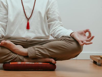 Close-up on hands in a meditative mudra position.
