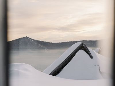 Silhouette of a person in a flowing yoga transition at sunrise.